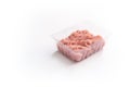 Minced meat in a transparent plastic container. Fresh pork minced meat, on white background. Royalty Free Stock Photo
