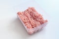 Minced meat in a transparent plastic container. Fresh pork minced meat, on white background. Royalty Free Stock Photo