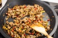Minced meat and veggies dices cooked on a black pan Royalty Free Stock Photo