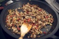 Minced meat and veggies dices cooked on a black pan Royalty Free Stock Photo