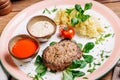 Minced mutton chop with boiled potatoes and sauce Royalty Free Stock Photo