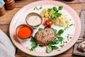 Minced mutton chop with boiled potatoes and sauce Royalty Free Stock Photo