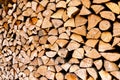 Minced wooden logs stacked in woodpile