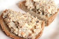 Mincemeat of herring on a slice of brown bread on white background close up view Royalty Free Stock Photo