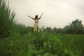 Mind and body connection with nature - middle aged attractive and happy Asian Chinese woman in Summer dress enjoying idyllic Royalty Free Stock Photo