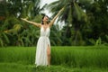 Mind and body connection with nature - middle aged attractive and happy Asian Chinese woman in Summer dress enjoying idyllic Royalty Free Stock Photo