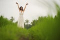 Mind and body connection with nature - middle aged attractive and happy Asian Chinese woman in Summer dress enjoying idyllic Royalty Free Stock Photo