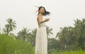 Mind and body connection with nature - middle aged attractive and happy Asian Chinese woman in Summer dress enjoying idyllic Royalty Free Stock Photo