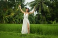 Mind and body connection with nature - middle aged attractive and happy Asian Korean woman in Summer dress enjoying idyllic