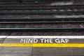 Mind the Gap sign on a train platform warning passengers to be cautious while boarding Royalty Free Stock Photo