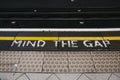 Mind the gap sign an a platform of Embankment underground station, London, UK Royalty Free Stock Photo