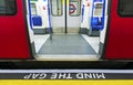 Mind the gap sign with speeding train in London underground