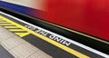 Mind the gap sign with speeding train in London underground Royalty Free Stock Photo