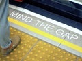 Mind the gap sign. text on train station platform