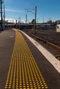 The mind gap warning on a platform at a train station, with yellow studs for the blind Royalty Free Stock Photo