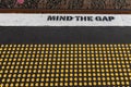 The mind gap warning at a train station, with yellow studs for the blind