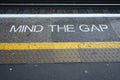 Mind The Gap with a yellow stripe painted onto a platform, London, England. Royalty Free Stock Photo