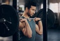 Mind over muscle - believe it before you do it. a muscular young man exercising with a barbell in a gym.