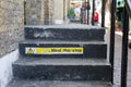 Mind The Step Sign on Worn and black Steps Royalty Free Stock Photo