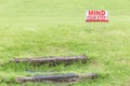 Mind your step warning sign to alert of natural wooden steps on Royalty Free Stock Photo