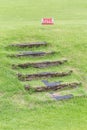 Mind your step warning sign to alert of natural wooden steps on Royalty Free Stock Photo