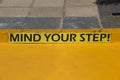 Mind your step warning sign in yellow Royalty Free Stock Photo