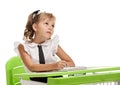 Minded schoolgirl at the desk Royalty Free Stock Photo