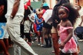 carnival crowd walking on the streets of the city with a cute small girl