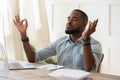 Mindful african american guy relaxing during remote working. Royalty Free Stock Photo