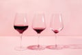 Mindful drinking and alcohol cutback concept. Three glasses with lowering levels of red wine poured Royalty Free Stock Photo