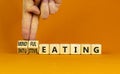 Mindful or intuitive eating symbol. Doctor turns cubes and changes words intuitive eating to mindful eating. Beautiful orange