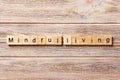 Mindful living word written on wood block. mindful living text on table, concept