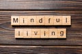 Mindful living word written on wood block. mindful living text on table, concept Royalty Free Stock Photo