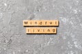 Mindful living word written on wood block. mindful living text on table, concept Royalty Free Stock Photo