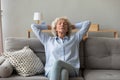 Mindful older mature grandmother sleeping on cozy sofa. Royalty Free Stock Photo