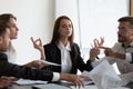 Mindful young business woman meditating, managing stress. Royalty Free Stock Photo