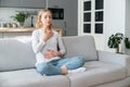 Mindful woman breathing deeply and managing stress at home