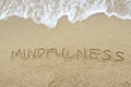 The word Mindfulness written on sand Royalty Free Stock Photo