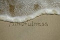 Mindfulness concept, mindful living, text written on the sand of beach Royalty Free Stock Photo