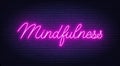 Mindfulness neon sign on brick wall background.