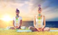 Couple doing yoga in lotus pose with seven chakras