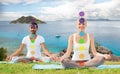 Couple doing yoga in lotus pose with seven chakras