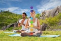 Couple doing yoga in lotus pose with seven chakras