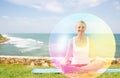 Woman doing yoga in lotus pose with rainbow aura