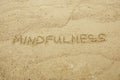 Mindfulness written on sand. Royalty Free Stock Photo