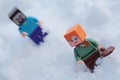 Minecraft LEGO figures of Steve and Alex walking in real deep snow.
