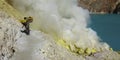 MINER COLLECTING SULFUR ON KAWAH IJEN VOLCANO Royalty Free Stock Photo