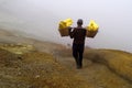 MINER COLLECTING SULFUR ON KAWAH IJEN VOLCANO Royalty Free Stock Photo