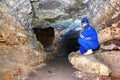Miner man underground in a mine tunnel. Worker in overalls, safety helmet