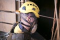 Miner worker wearing a ear plug noise safety protection when working near operating life plant machinery